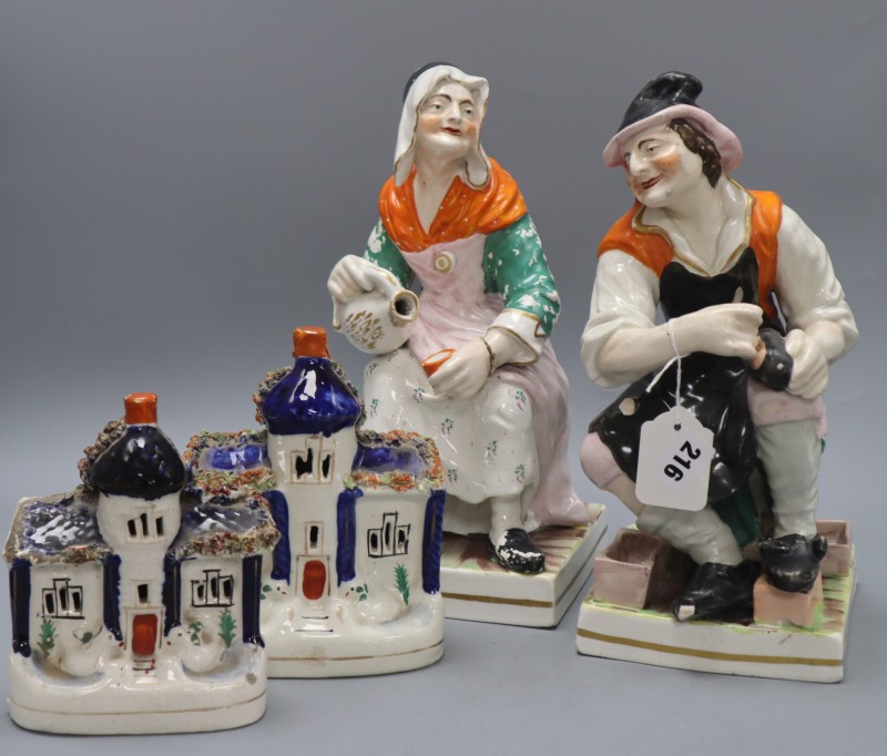 A pair of large Staffordshire pottery figures of the cobbler and his wife and a pair of Staffordshire houses, tallest 31cm